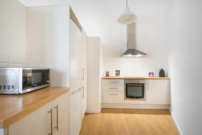 a kitchen with white cabinets and a microwave at Barcelona Just Like Home in Barcelona