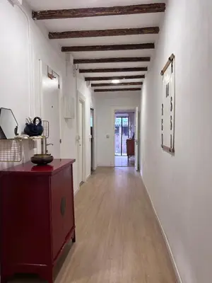 a hallway with white walls and a wooden ceiling at Alojamiento con encanto en planta superior ideal para trabajo y escapadas familiares en Montserrat in Esparreguera