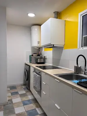 a kitchen with white cabinets and a sink and a dishwasher at Alojamiento con encanto en planta superior ideal para trabajo y escapadas familiares en Montserrat in Esparreguera