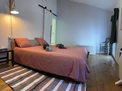 a bedroom with a bed with two dogs laying on it at Alojamiento con encanto en planta superior ideal para trabajo y escapadas familiares en Montserrat in Esparreguera