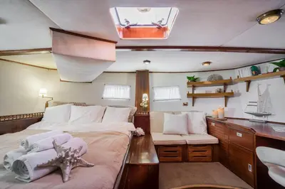 a bedroom with a bed and a desk in a boat at SPACIOUS YACHT HOTEL BARCELONA CITY CENTER 5 CABINs in Barcelona
