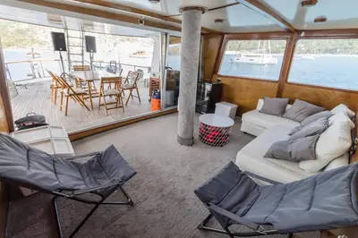 a living room with a couch and chairs and a table at SPACIOUS YACHT HOTEL BARCELONA CITY CENTER 5 CABINs in Barcelona