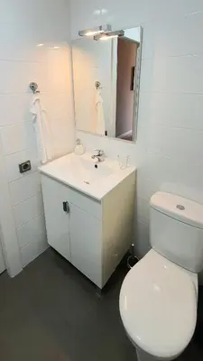 a white bathroom with a toilet and a sink at Lovely Appart & Sky View SAGRADA FAMILIA in Barcelona