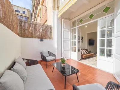 a living room with a couch and a table at BarcelonaForRent The Living Terrace in Barcelona