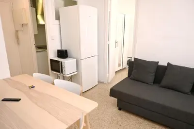 a living room with a couch and a table at Homenfun Barcelona Park Güell in Barcelona