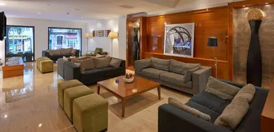 a large living room with couches and a table at NH Barcelona Eixample in Barcelona