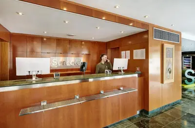 a man standing in front of a mirror at Sercotel Cornellà Barcelona in Cornellà de Llobregat
