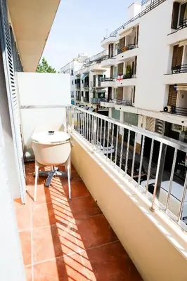 a balcony with a table and a view of a building at Hotel Subur in Sitges