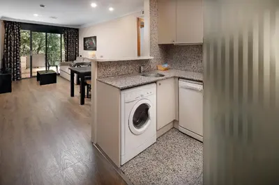 a kitchen with a washer and dryer in a room at Apartaments-Hotel Hispanos 7 Suiza in Barcelona