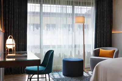 a hotel room with a desk and chair and a window at Renaissance Barcelona Hotel in Barcelona