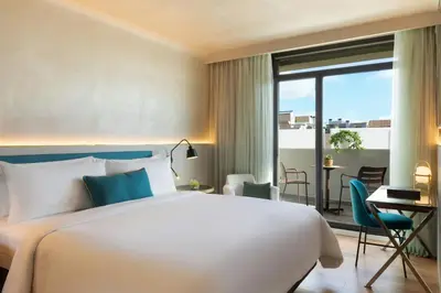a hotel room with a bed and a balcony at Renaissance Barcelona Hotel in Barcelona