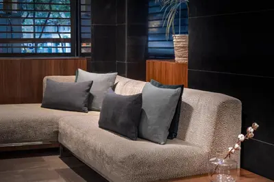 a couch with four pillows on it in a room at AC Hotel Irla by Marriott in Barcelona
