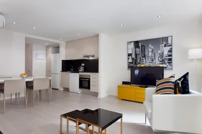 a living room with a kitchen and a dining room at BarcelonaForRent Urban Town Suites in Barcelona