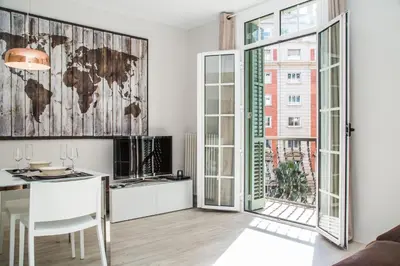 a living room with a table and a world map on the wall at BarcelonaForRent Urban Town Suites in Barcelona