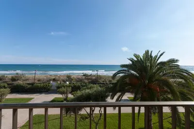 a view of the beach from the balcony of a condo at LETS HOLIDAYS Beach front apartment in Gavà Mar, Pine Beach in Gavà