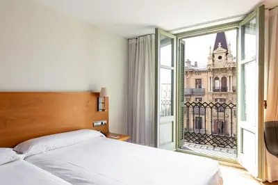 a bedroom with a bed and a large window at Onix Rambla in Barcelona
