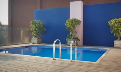 a swimming pool in a building with a blue wall at Onix Rambla in Barcelona