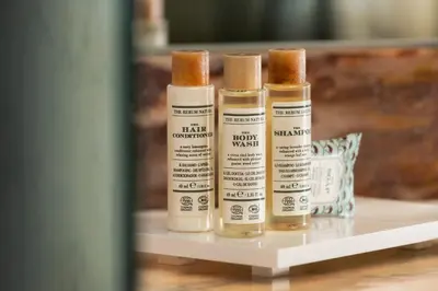 three bottles of moisturizers sitting on a shelf at Salles Ciutat del Prat Barcelona Airport in El Prat de Llobregat