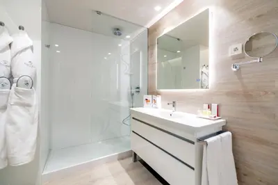 a bathroom with a white sink and a shower at Sallés Hotel Pere IV in Barcelona