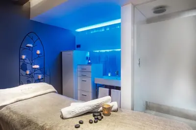 a blue bedroom with a bed and a sink at Sallés Hotel Pere IV in Barcelona