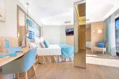 a hotel room with a bed and a desk at Sumus Hotel Stella and Spa 4S Adults Recommended in Pineda de Mar