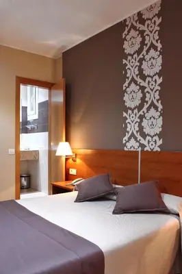 a bedroom with a large bed and a window at Catalunya in Barcelona