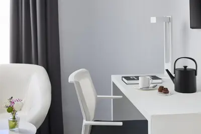 a white desk with a white chair in a room at NH Barcelona Stadium in Barcelona