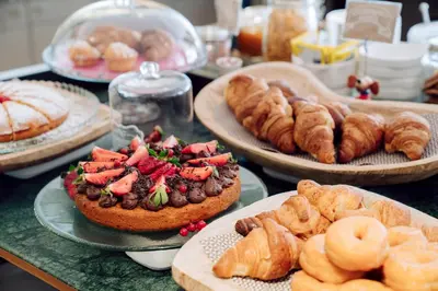 a table topped with plates of pastries and pies at Chic & Basic Velvet in Barcelona