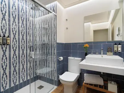 a bathroom with a toilet and a sink and a shower at H10 Universitat in Barcelona
