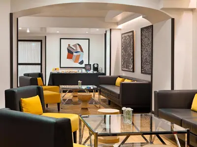 a living room with couches and a table at H10 Universitat in Barcelona
