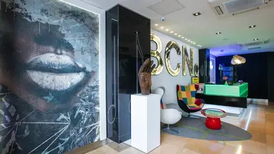 a large picture of a face on a wall in a room at Evenia Rocafort in Barcelona