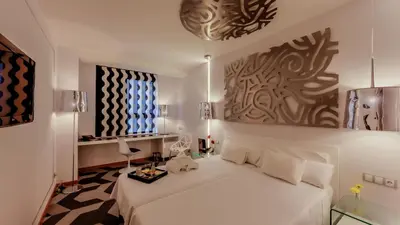 a bedroom with a white bed in a room at Evenia Rossello in Barcelona