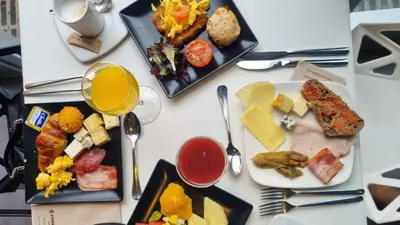 a table topped with plates of food and drinks at Evenia Rossello in Barcelona