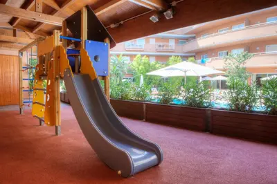 a playground with a slide in a building at Sunway Playa Golf & Spa Sitges in Sitges