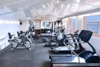a gym with rows of treadmills and exercise bikes at Sunway Playa Golf & Spa Sitges in Sitges