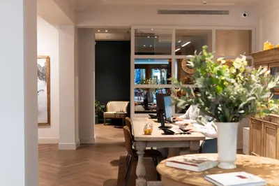 a store with a table with flowers on it at Mesón Castilla Atiram Hotels in Barcelona