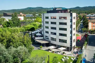 an aerial view of a building with a sign on it at El Sant Cugat, 4 estrellas superior in Sant Cugat del Vallès