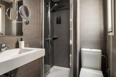 a bathroom with a shower and a sink and a toilet at BYPILLOW Mothern in Barcelona