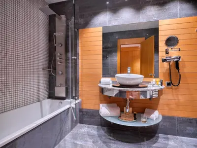 a bathroom with a sink and a bath tub at Sansi Pedralbes in Barcelona