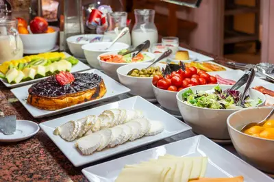 a table topped with plates of food and bowls of food at Sunotel Junior in Barcelona