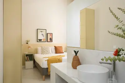 a bathroom with a sink and a bed in a room at Casa Cosi Don Bajos in Barcelona