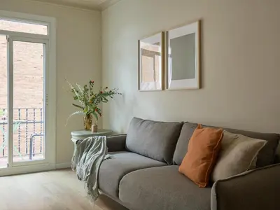 a living room with a couch and a window at Casa Cosi El Farro 4 in Barcelona