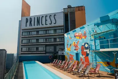a swimming pool on the roof of a building with a mural at Barcelona Princess in Barcelona