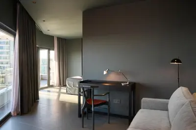 a room with a table and a bed and a desk at Barcelona Princess in Barcelona