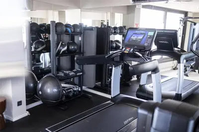 a room with a gym with a treadmill and weights at Via Sants Hotel Barcelona, Tapestry Collection By Hilton in Barcelona