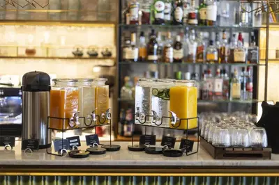 a bar with a counter with some drinks on it at Via Sants Hotel Barcelona, Tapestry Collection By Hilton in Barcelona