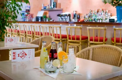 a table with bottles and glasses on it in a restaurant at Mercè in Pineda de Mar