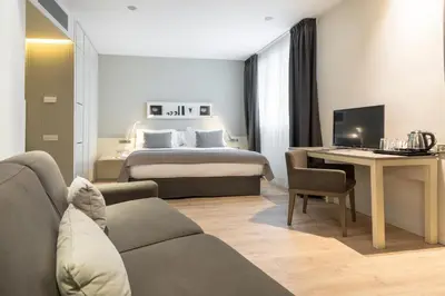 a hotel room with a bed and a desk at Sercotel Amister Art Hotel Barcelona in Barcelona