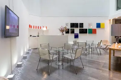 a room with chairs and a table and a tv at Sercotel Amister Art Hotel Barcelona in Barcelona