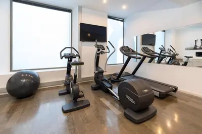 a gym with treadmills and exercise bikes in a room at Sercotel Amister Art Hotel Barcelona in Barcelona